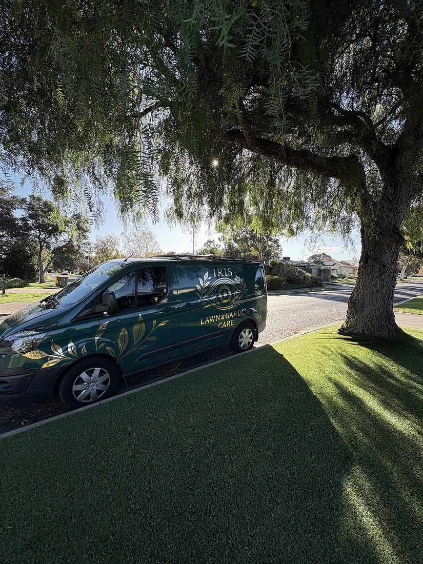 Iris Lawn & Garden Care branded van parked by a lawn verge